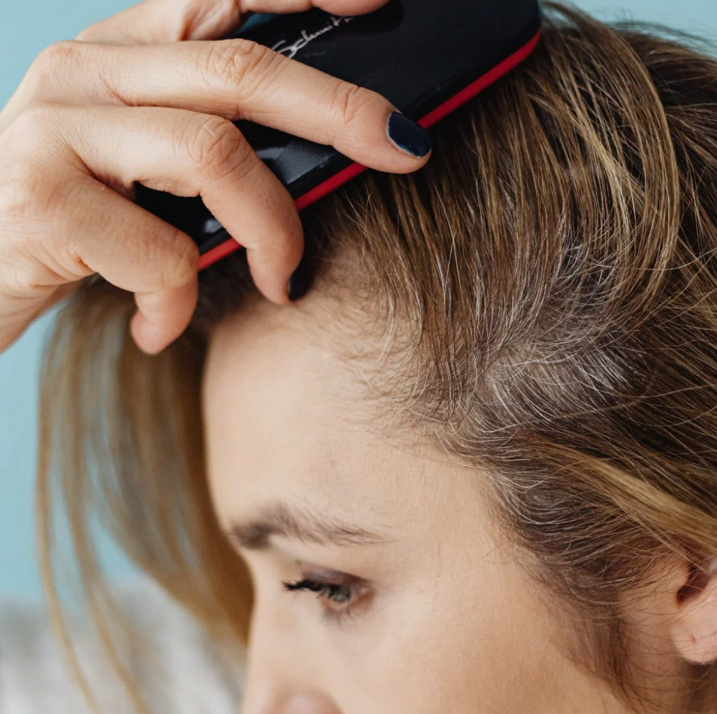 A mature woman brushing her hair