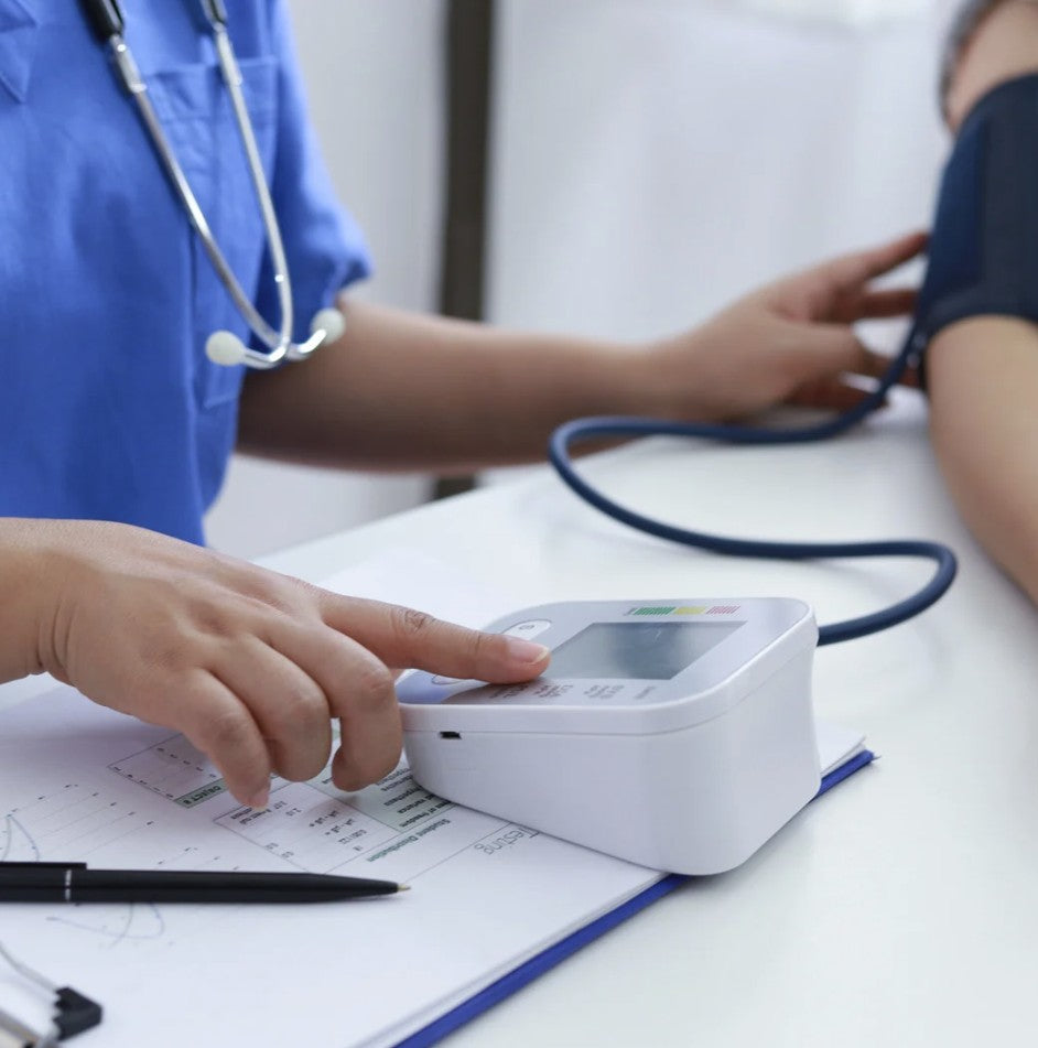 A perimenopausal woman taking her blood pressure