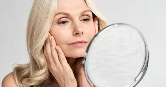 Mature woman applying skincare to manage hormonal skin changes during menopause