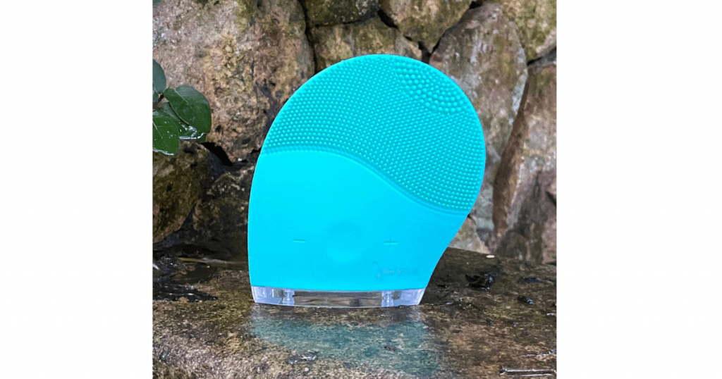 Silicone face cleansing brush resting on a bathroom surface, choosing a brush type for skin after 45