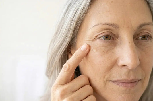 Woman with crow's feet and fine lines around eyes, common signs of reduced collagen and estrogen loss affecting skin elasticity during menopause