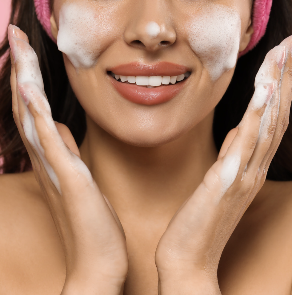 A woman cleansing her face