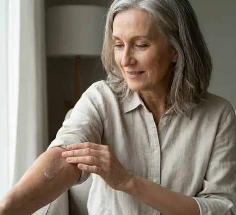 A woman applying gel to a scar