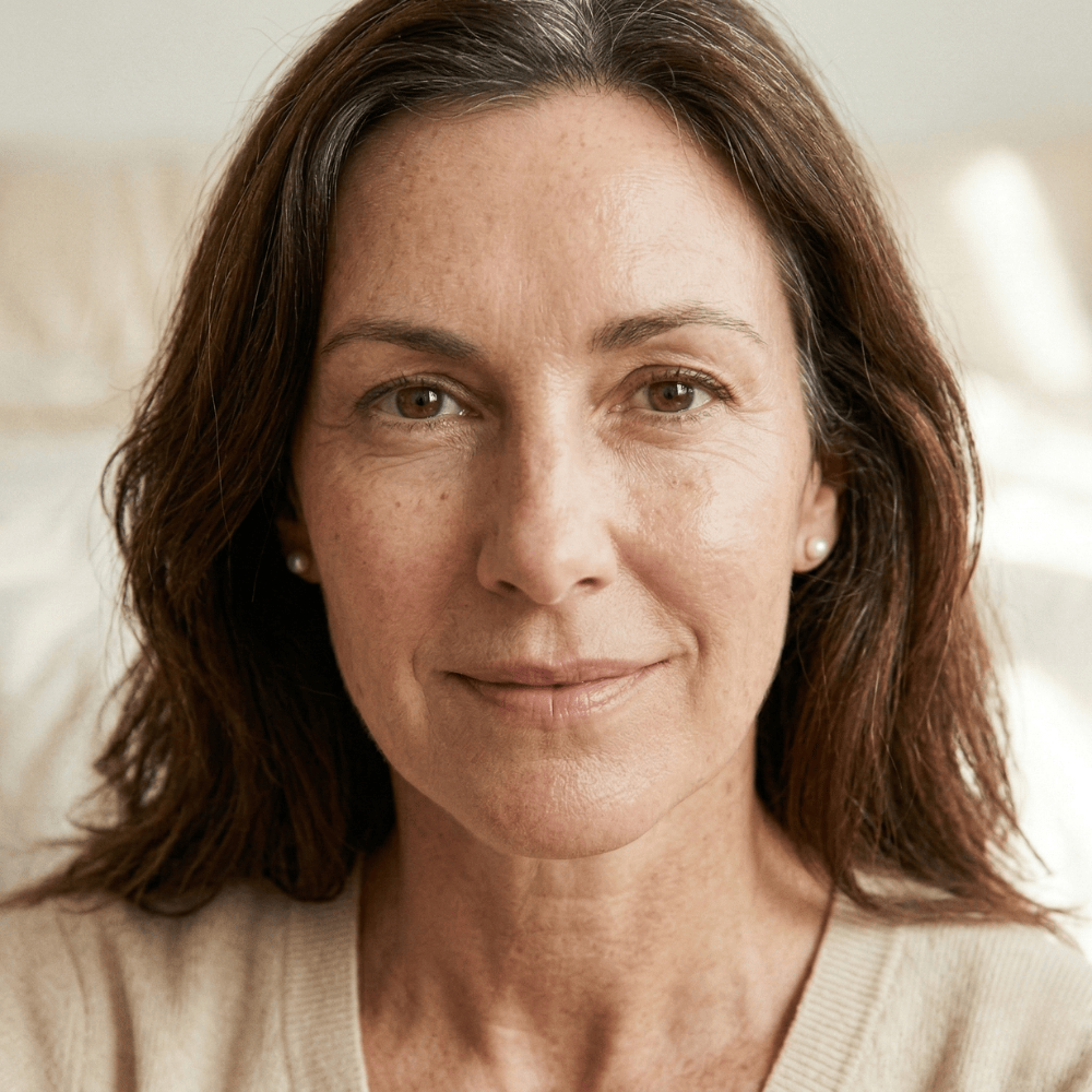 Woman in her 50s with natural skin showing early fine lines and expression wrinkles, the stage where a targeted anti-wrinkle serum can make the most difference