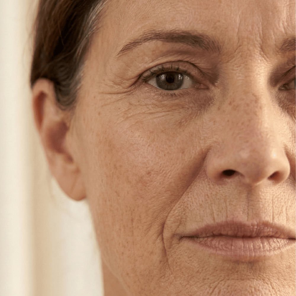 Close-up of fine lines, wrinkles and loss of skin elasticity on a mature woman's face, common signs of collagen decline during menopause