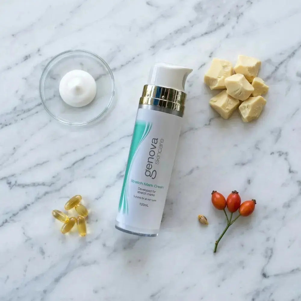 Genova Stretch Mark Cream 120ml flat lay on marble with shea butter, rosehip and vitamin E capsules, nourishing stretch mark cream for pregnancy and postpartum skin