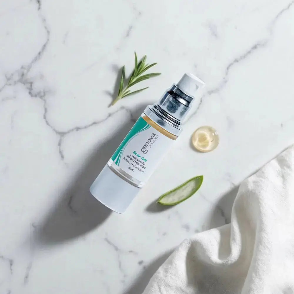 Genova Silicone Scar Gel 30ml flat lay on marble with rosemary, cucumber and vitamin E, medical-grade scar treatment for surgical and injury scars