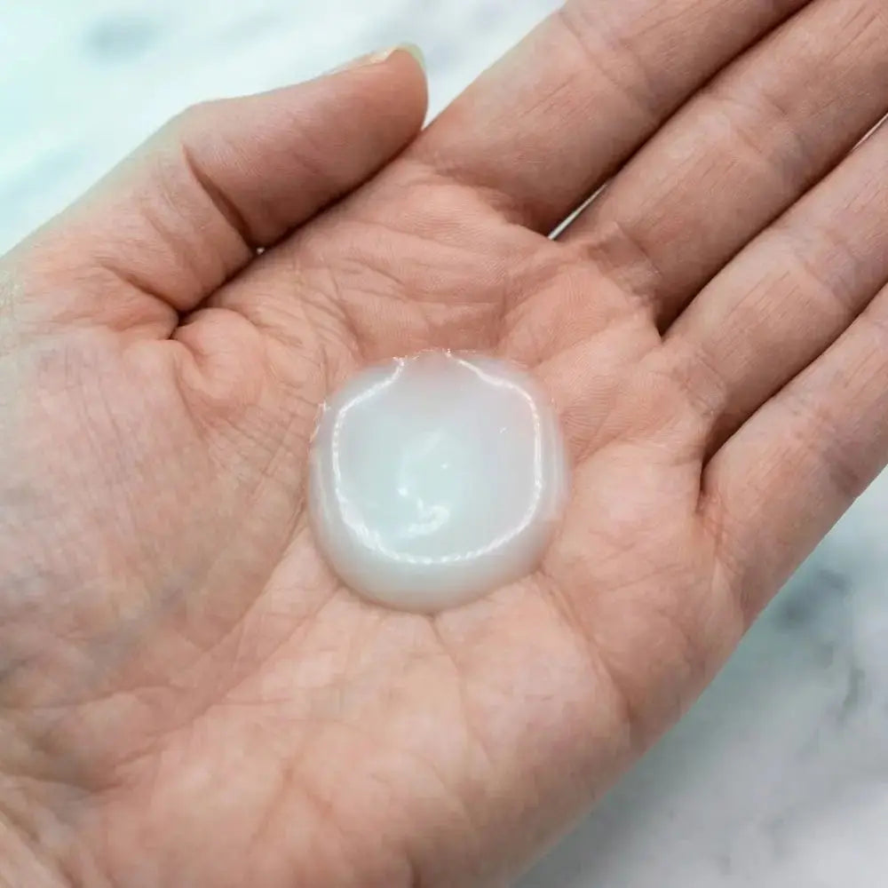Close-up of Genova Red Active Serum texture in the palm, showing lightweight gel consistency for gentle application on redness-prone and sensitive skin