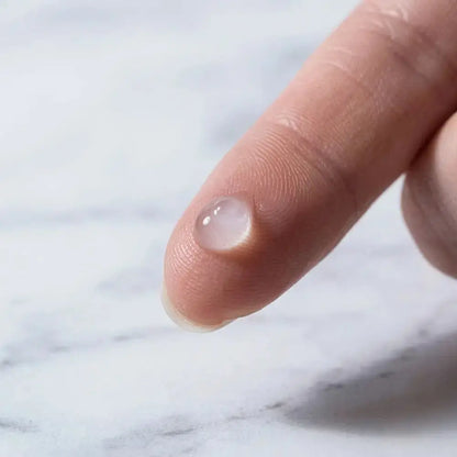 Genova Skincare Blemish Spot Gel clear gel drop on fingertip showing lightweight texture for targeted acne spot treatment